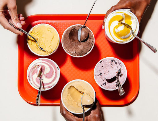 Double Rainbow pints of ice cream open on a red serving tray ready to eat